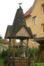 Wooden vintage old well with a stork on top.