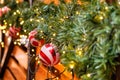 Wooden Vintage Restaurant Building Decorated of Artificial Fir Tree with Lighting Garland and many Red and White Christmas Balls Royalty Free Stock Photo