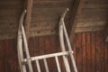 Wooden vintage sleigh leaning against the wall. Rustic barn in alps with retro sled close-up. Royalty Free Stock Photo