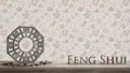 Wooden vintage table shelf with ba gua and 3d letters making the word feng shui with abstract floral background with copy space, Royalty Free Stock Photo