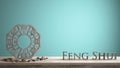 Wooden vintage table shelf with ba gua and 3d letters making the word feng shui with turquoise ciano background with copy space,