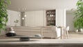 Wooden vintage table or shelf with stone balance, over blurred modern white kitchen with wooden details and parquet floor, feng