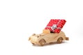 Wooden vintage toy car with a red box, gift on a white background. Royalty Free Stock Photo