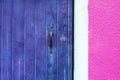 Wooden violet door and pink wall Royalty Free Stock Photo