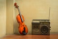 Wooden violin with old style radio Royalty Free Stock Photo