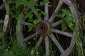 wooden wagon wheel against the backdrop of a rural landscape Royalty Free Stock Photo