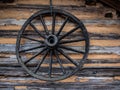 Wooden Wagon Wheel on Side of Log Cabin Royalty Free Stock Photo