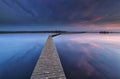 Wooden walkpath on water at dawn Royalty Free Stock Photo