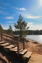 Wooden walkboard that leads to the lakeside. Walk around lake in a sunny day