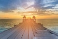 Wooden walking path leading to sunset seacoast skyline Royalty Free Stock Photo