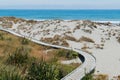 Wooden walking path over sand beach Royalty Free Stock Photo