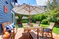 Wooden walkout deck in the backyard garden of blue siding house. Royalty Free Stock Photo