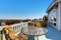 Wooden walkout deck with outdoor settees and hot tub