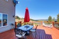 Wooden walkout deck with patio table overlooking beautiful landscape