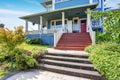 Wooden walkout porch of craftsman American house in blue tones