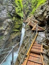 wooden walkpath as bridge over cascading waterfall Royalty Free Stock Photo