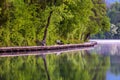 Wooden walkway around the lake Bled with mountains and houses on the background. Beautiful Slovenian Nature. Bled, Slovenia, Royalty Free Stock Photo