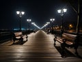 a wooden walkway with benches and street lights at night