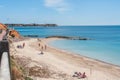 Wooden walkway on a cliff over a sandy beach on a clear summer day in Spain