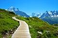 Wooden walkway in the mountain landscape. Nature Reserve Aiguilles Rouges, French Alps.