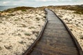 Wooden walkway over sand to ocean shore Royalty Free Stock Photo