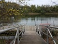 Wooden walkway or ramp floating platform and picnic table and lake Royalty Free Stock Photo