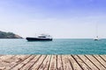 Wooden walkway on sea and blue sky with boat Royalty Free Stock Photo