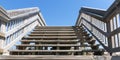 Wooden walkway stairs going over sand dunes leading to blue skies above Royalty Free Stock Photo