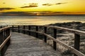 Wooden walkway to the beach at sunrise in Alicante, Spain Royalty Free Stock Photo