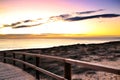 Wooden walkway to the beach at sunrise in Alicante, Spain Royalty Free Stock Photo