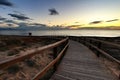 Wooden walkway to the beach at sunrise in Alicante, Spain Royalty Free Stock Photo