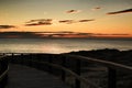 Wooden walkway to the beach at sunrise in Alicante, Spain Royalty Free Stock Photo