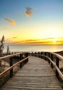 Wooden walkway to the beach at sunrise in Alicante, Spain Royalty Free Stock Photo