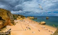 Wooden walkway to famous Praia Dona Ana beach with turquoise sea water and cliffs, flying seagulls over the beach, Portugal.