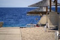 Wooden Walkway To Sand Beach with Sunshades Royalty Free Stock Photo