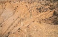 Wooden walkways and stairs of a path in arid terrain to descend into a ravine.