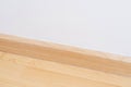 Wooden wall base skirting, finishing material with wood laminate floor and white mortar wall. Empty room with white wall and Royalty Free Stock Photo