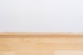 Wooden wall base skirting, finishing material with wood laminate floor and white mortar wall Royalty Free Stock Photo