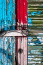 Wooden wall with very old dried paint. Worn painted surface. Creative abstract texture background of peeling paint in blue, red Royalty Free Stock Photo