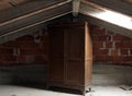 Wooden wardrobe in the dusty uninhabited attic