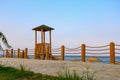 A wooden watchtower on the embankment for lifeguards to watch swimming tourists having a rest. Background