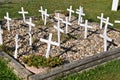 Box of rocks honoring fallen soldiers with white crosses