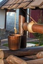 Wooden well. Bucket on a rope Royalty Free Stock Photo