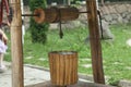 Wooden well in the summer garden. Cozy courtyard in the park,