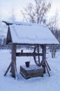 Wooden well in winter village Royalty Free Stock Photo