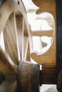 Wooden wheel of ancient peasant wagon close up view