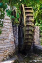 Wooden wheel of an ancient water mill in Botanical Gardens of Balchik and Palace of the Romanian Queen Marie in Bulgaria