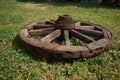 Wooden wheel on a background of green grass