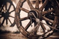 Wooden wheels of an old cart standing in the yard in a village in the countryside. Vintage objects of the past. History