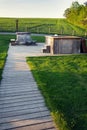 Wooden whirlpool and hot tub during sunset in beautiful summer rural landscape Royalty Free Stock Photo